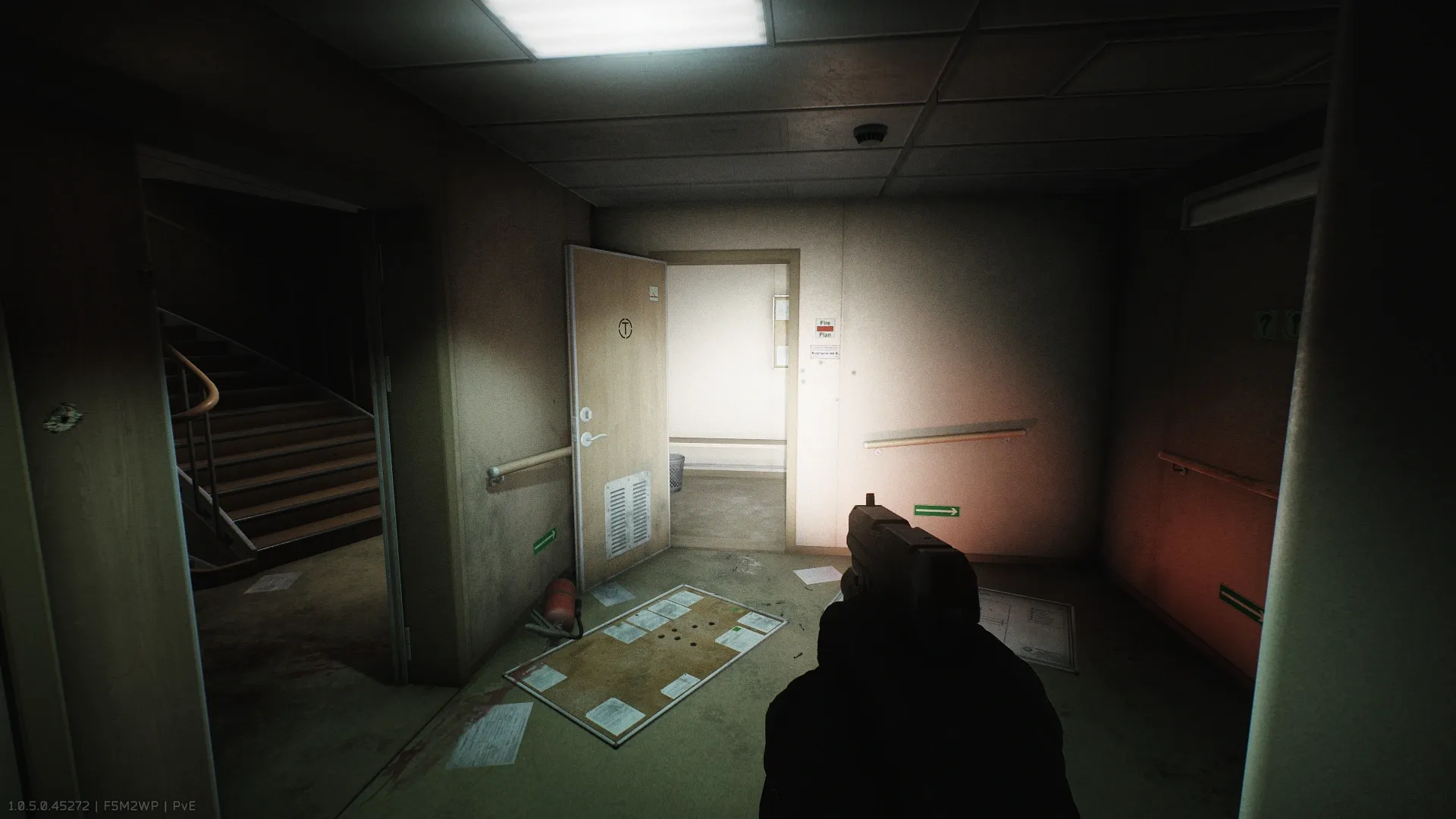 The door next to the stairs leading to the intercom