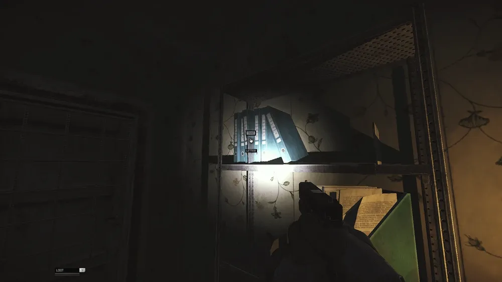 The letter between the binders on the shelf