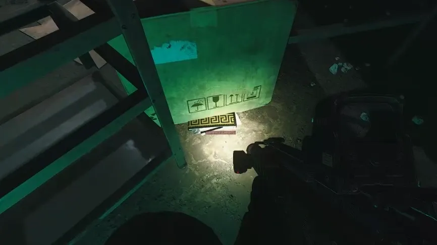 7: On the ground tucked under one of the packages next to the front missile part